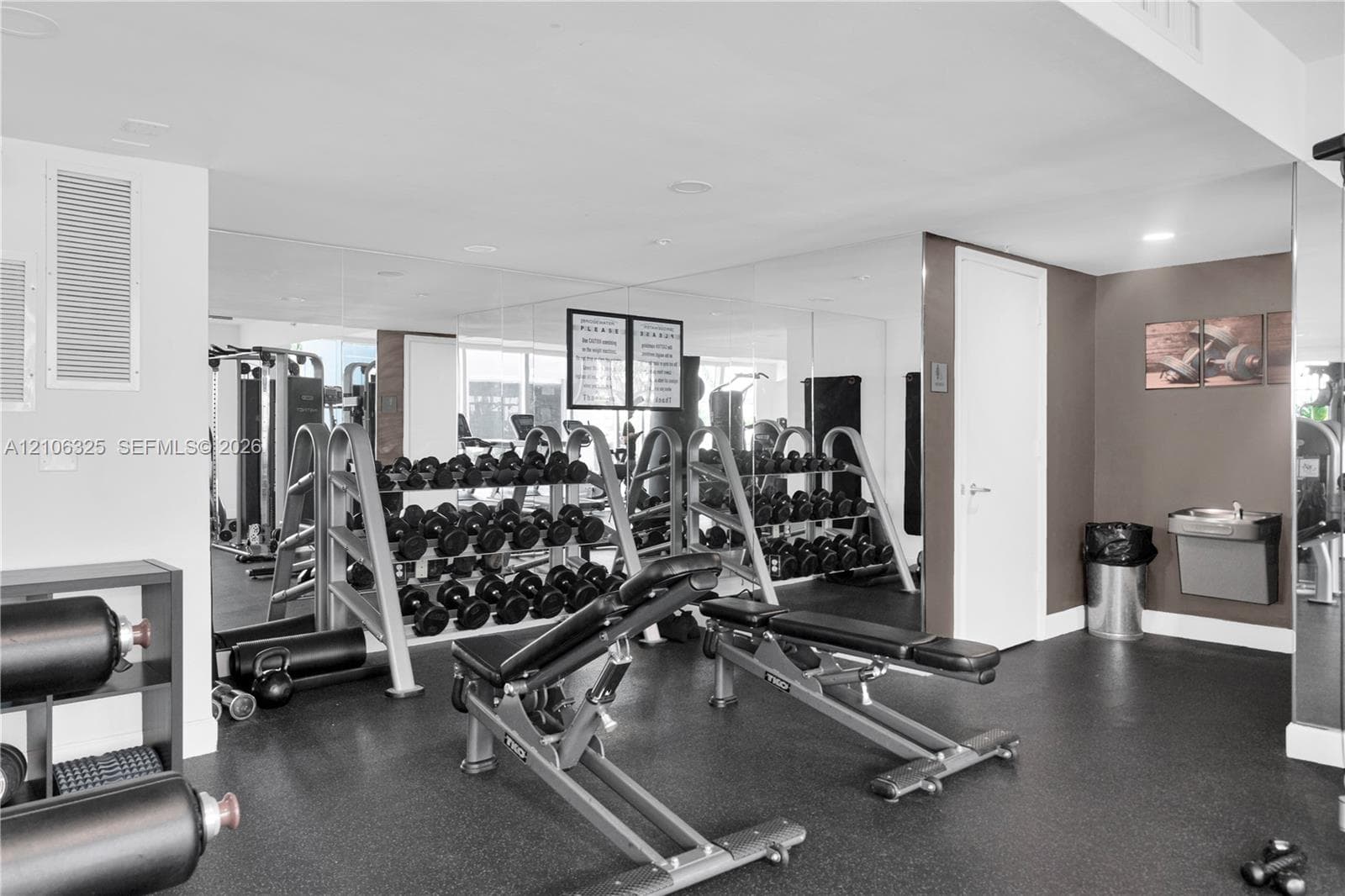 Full-wall mirrors, recessed lighting, and rubberized flooring