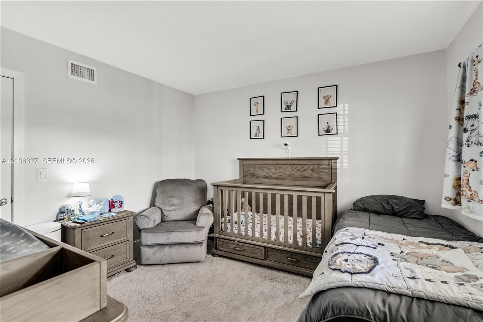 Neutral wall paint, light-toned carpeting, and white interior door