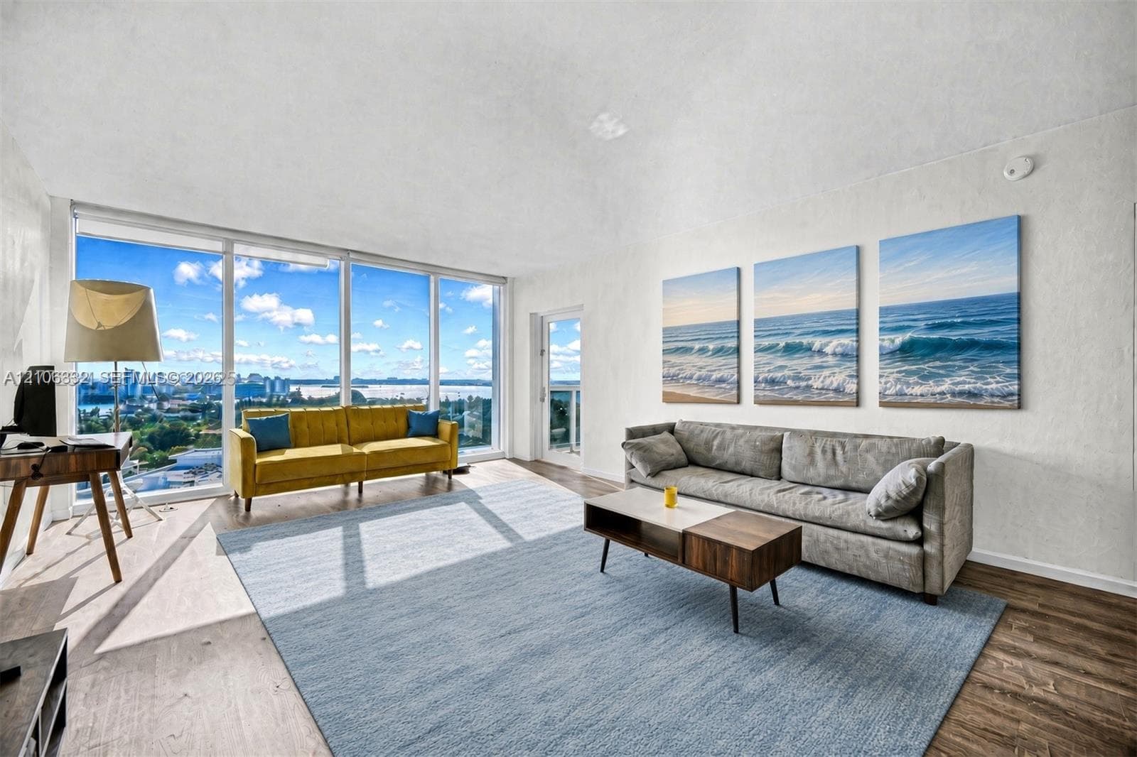 Living area featuring vaulted ceilings, floor-to-ceiling glass windows, and wood-finish flooring