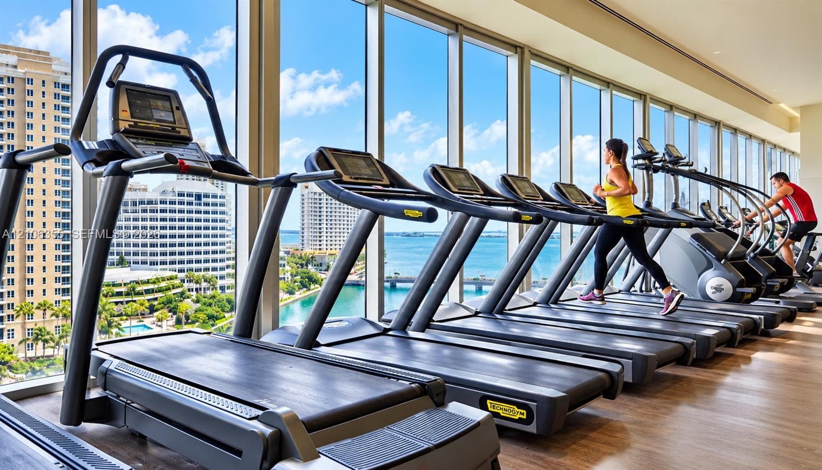 Fitness center featuring floor-to-ceiling windows and wood-finish flooring