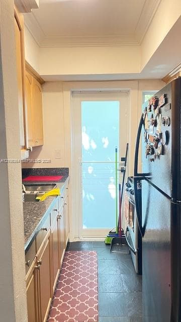 Kitchen featuring light-finish cabinetry, stone-texture countertops, tile flooring, and a glass-paneled exterior door