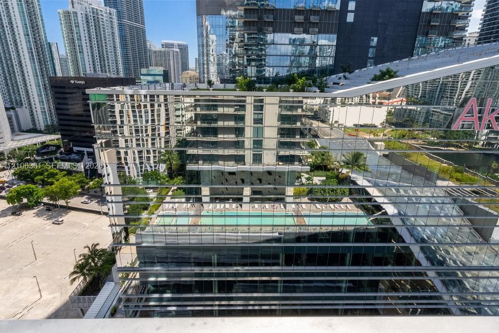 High-rise urban landscape featuring a swimming pool, expansive glass facade architecture, and landscaped terrace areas