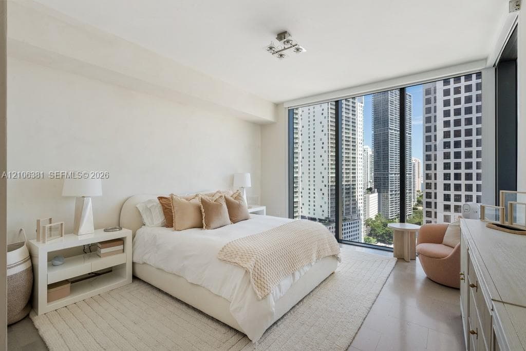 Floor-to-ceiling windows, neutral interior finishes, and minimalist ceiling-mounted lighting