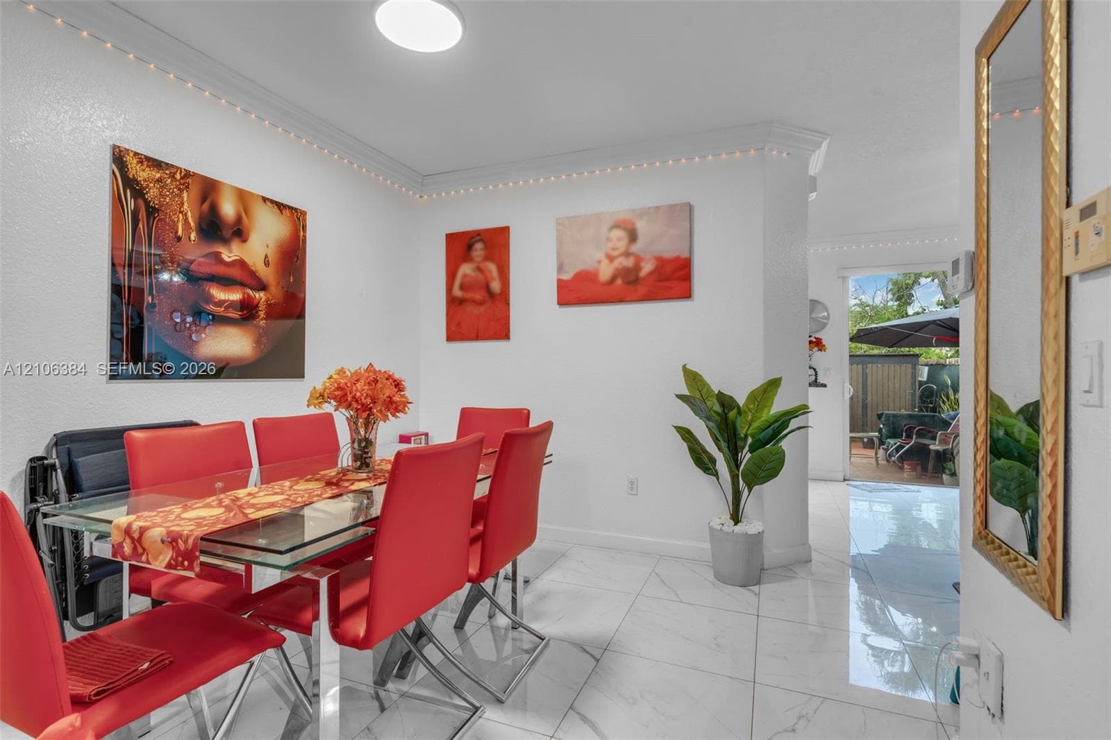 Large-format tile flooring, neutral wall finish, and crown molding
