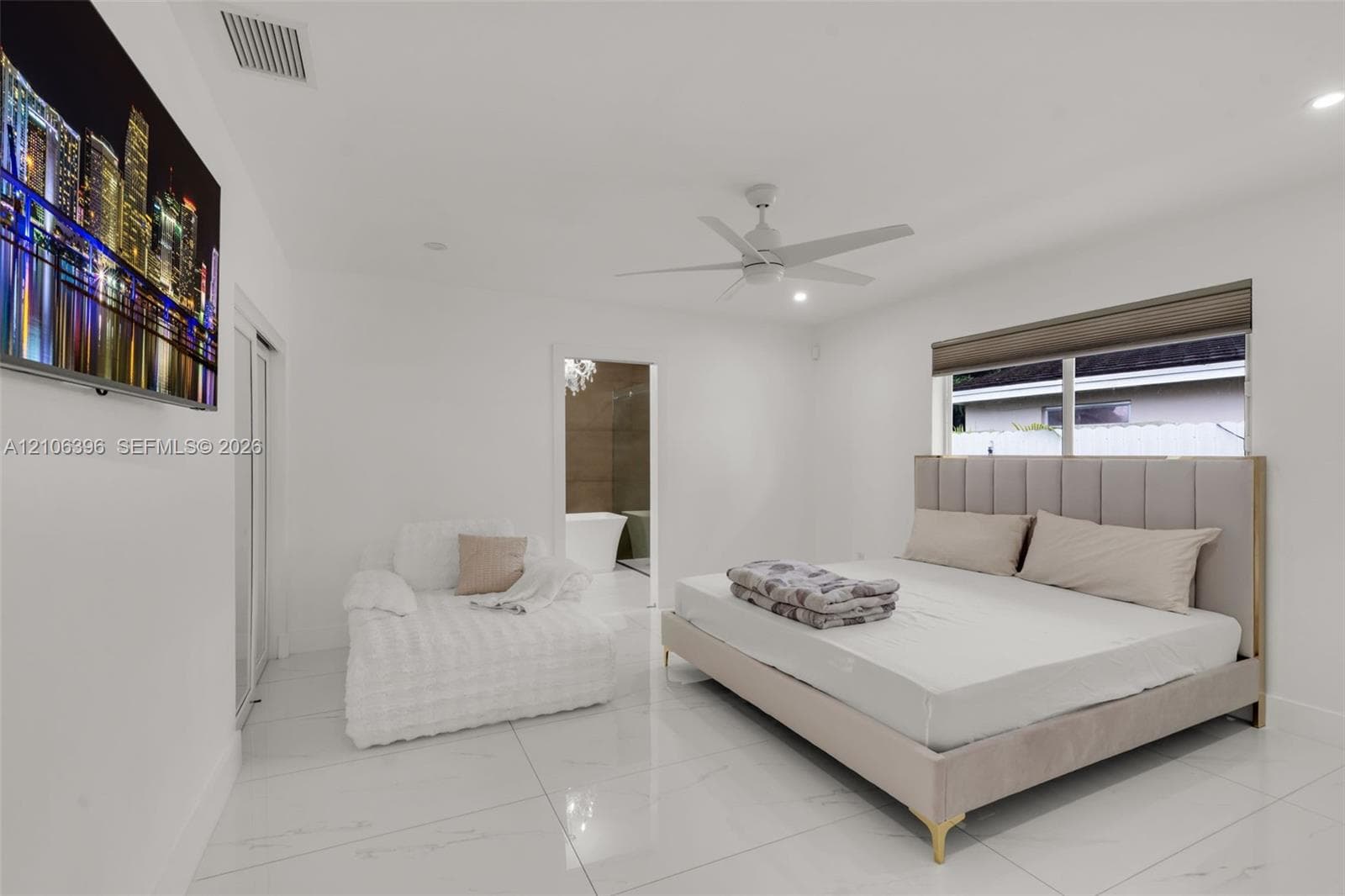 Spacious room featuring polished tile flooring, recessed lighting, a white ceiling fan, and large windows with integrated shades
