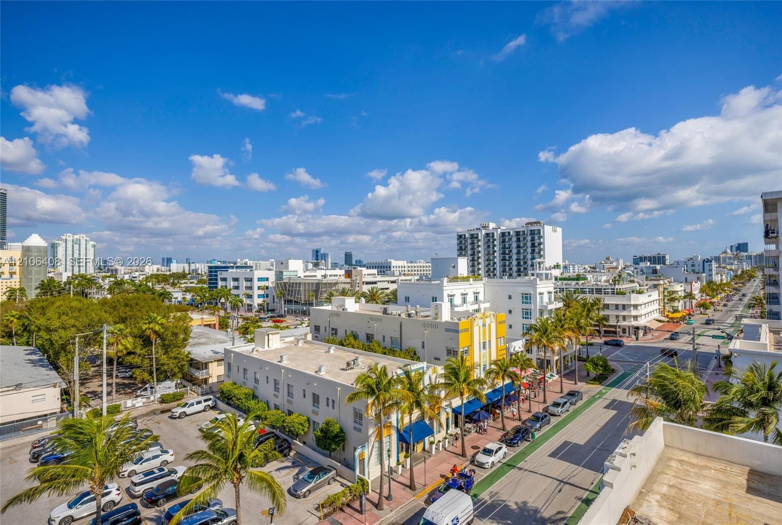 Aerial perspective featuring urban streetscapes, dense palm tree landscaping, and surrounding mid-rise architecture