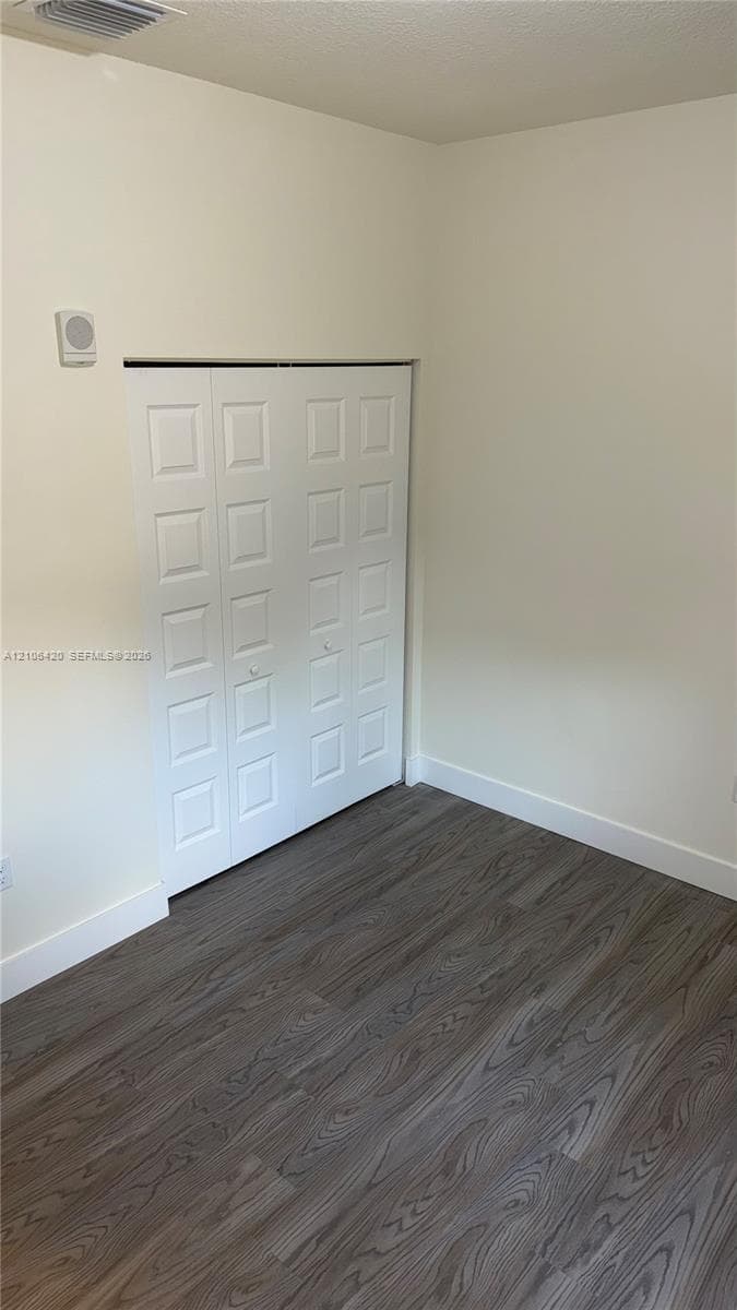 Interior space featuring wood-finish flooring and a white paneled closet door