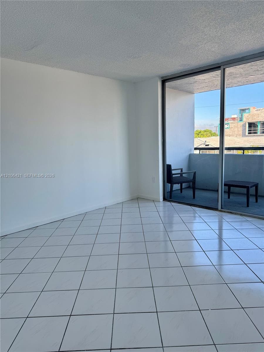 Ceramic tile flooring, sliding glass door, and private balcony
