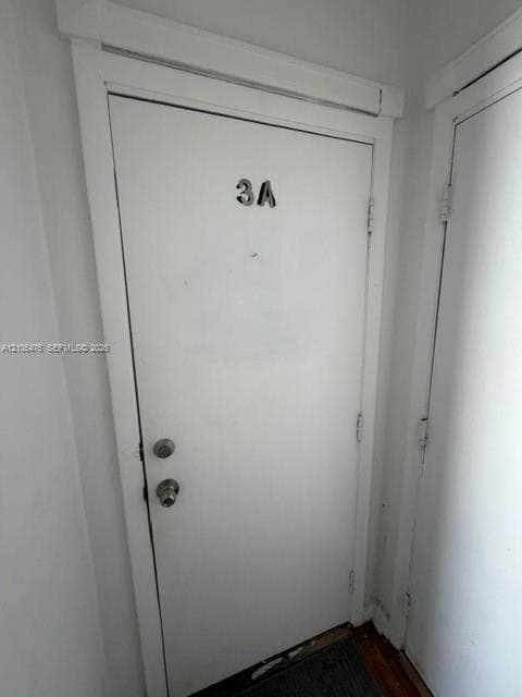 Solid-core entry door featuring a polished metal deadbolt and matching handle set