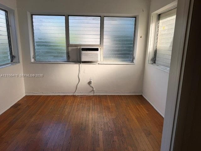 Wood-finish flooring and expansive louvered glass windows