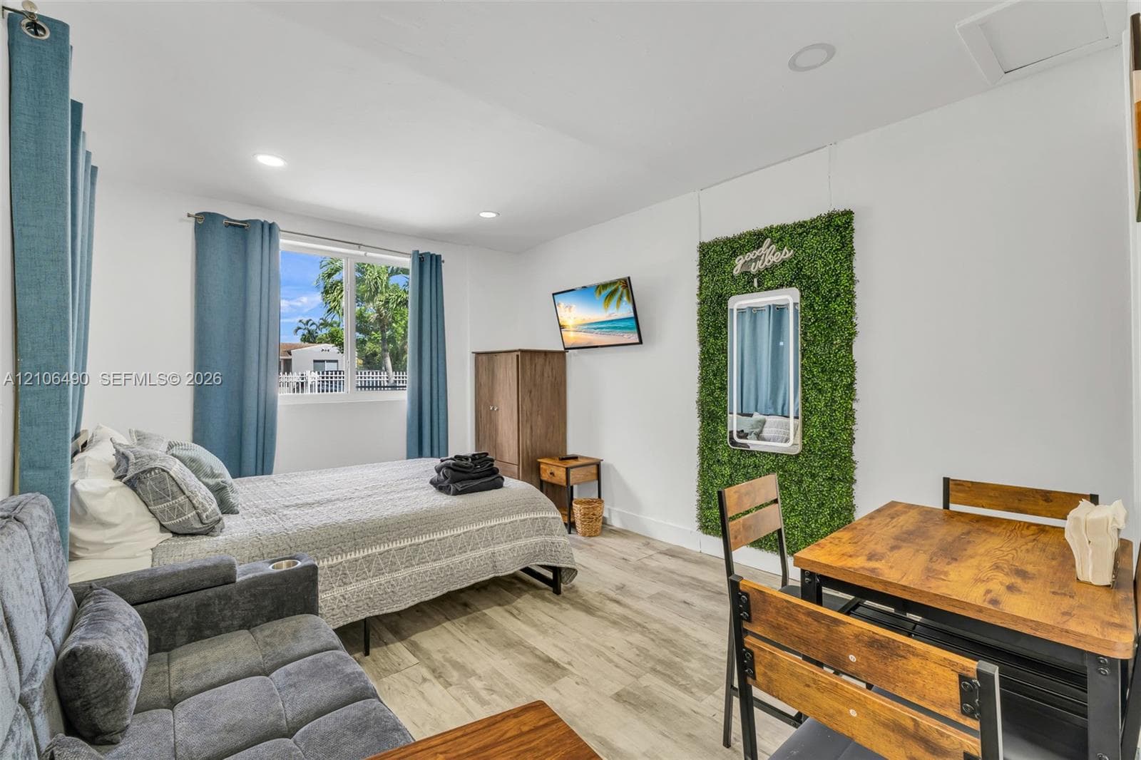 Wood-finish flooring, recessed lighting, and a large window with exterior exposure