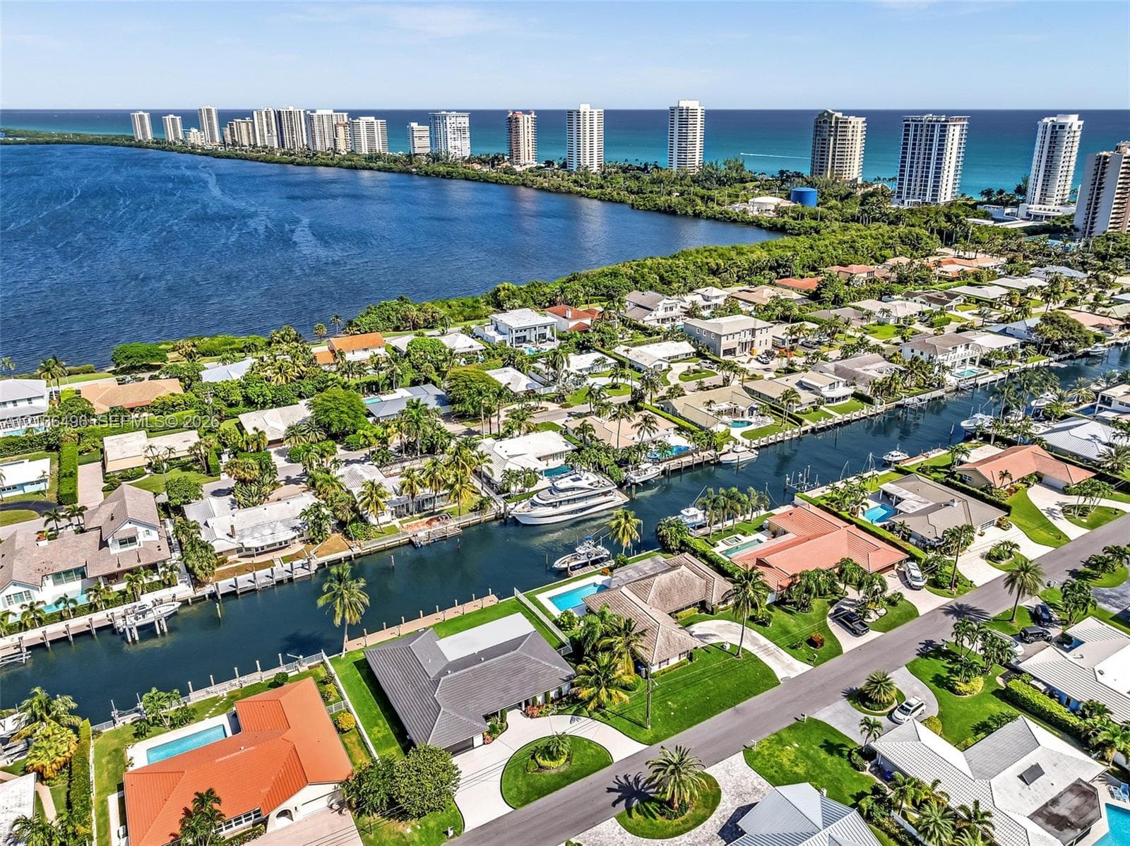 Waterfront aerial perspective featuring direct canal access, private boat dockage, and coastal scenery