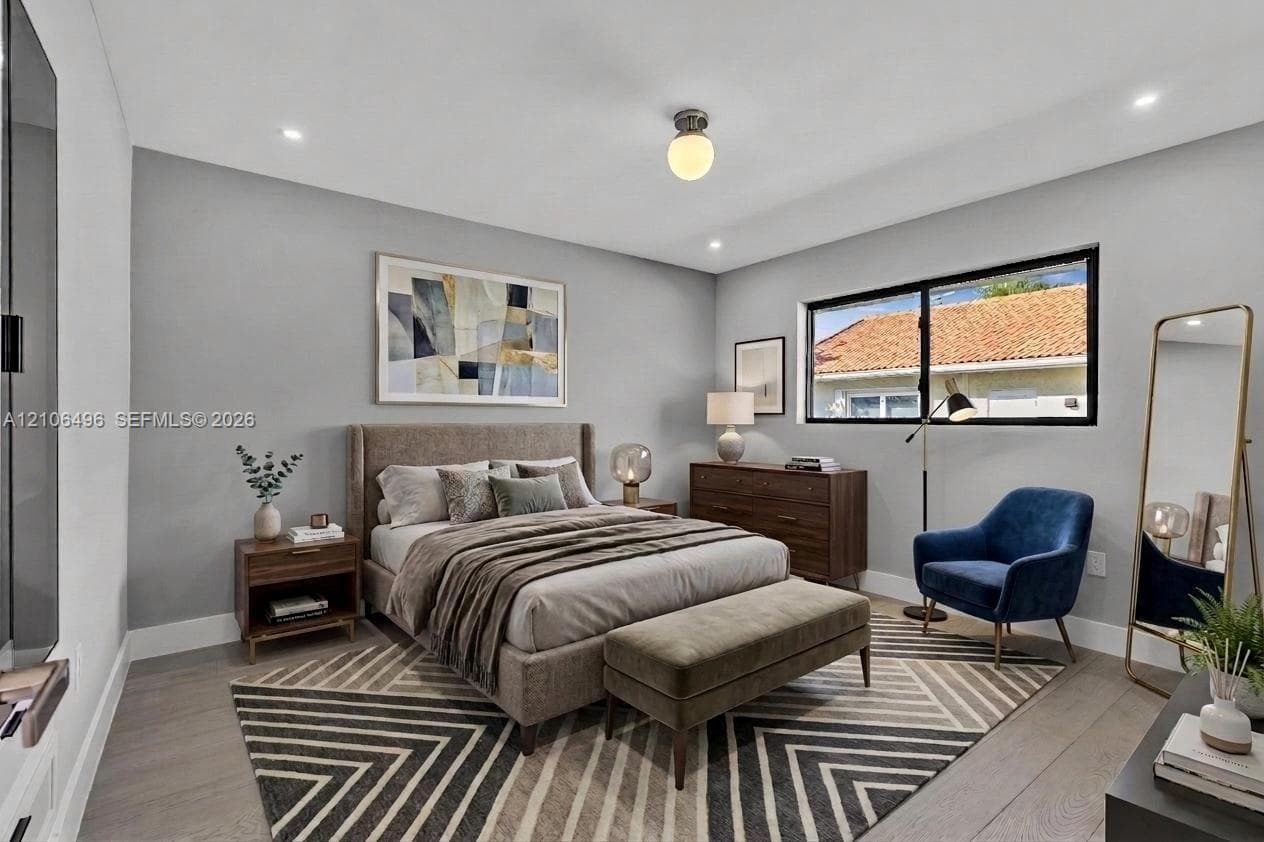 Neutral-toned bedroom featuring wood-finish flooring, recessed lighting, and a single-globe ceiling fixture
