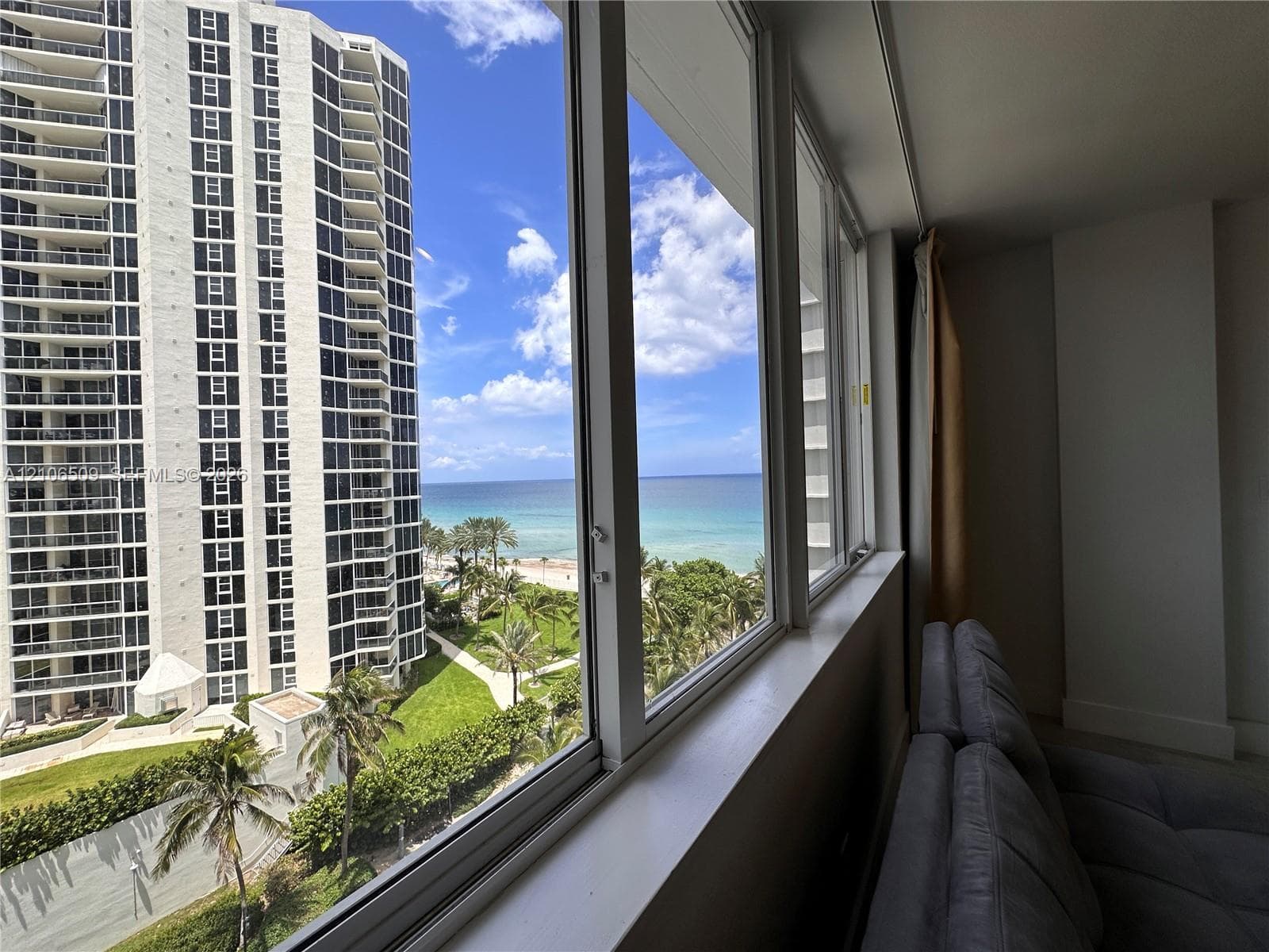 Floor-to-ceiling windows featuring ocean and coastline scenery