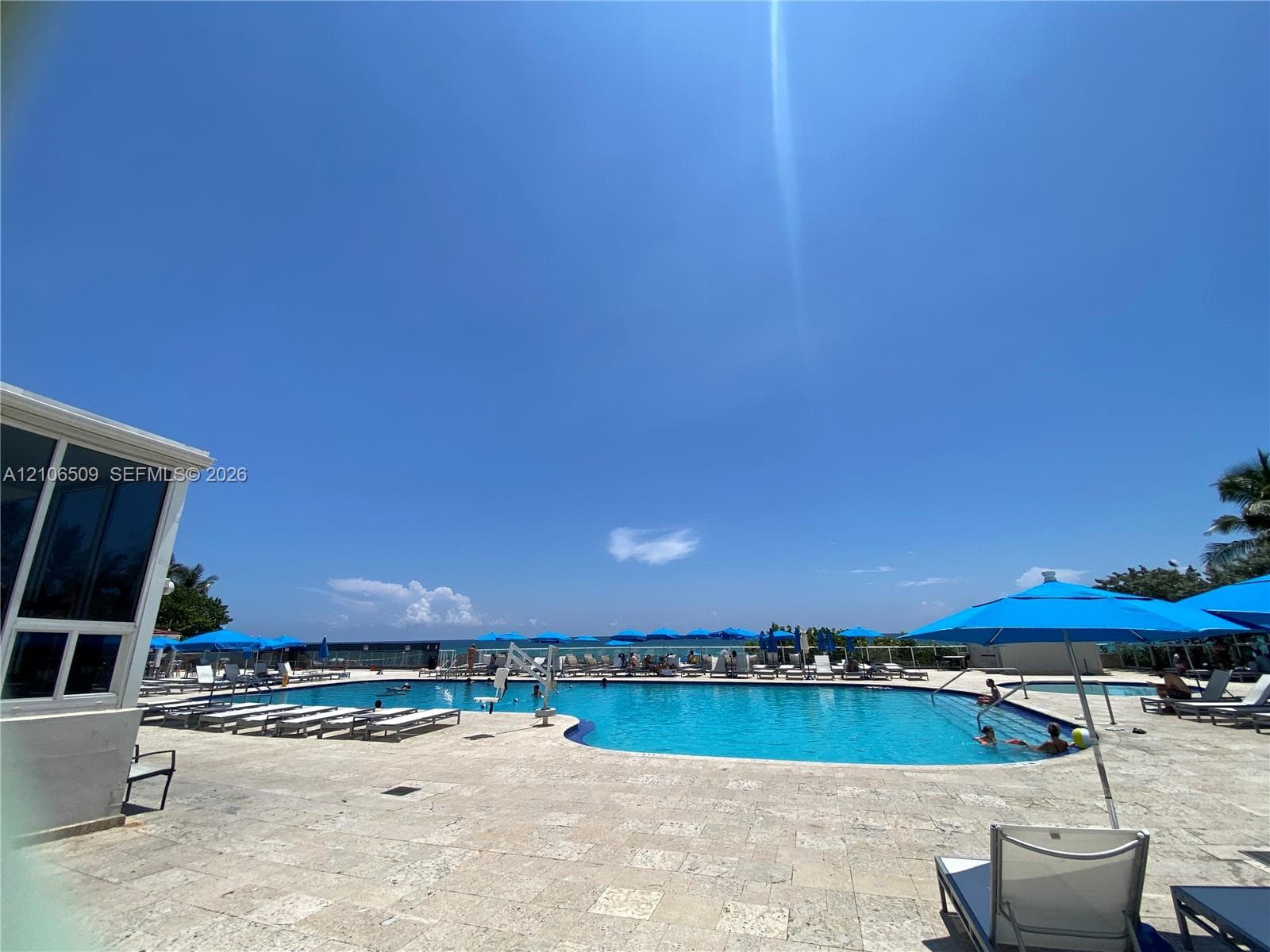 Inground swimming pool with stone-tile decking and recessed steps