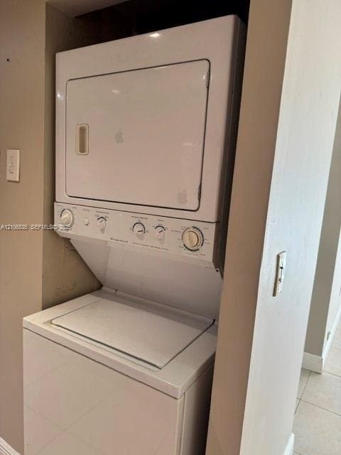 Stacked white laundry center featuring a top-loading washer and front-loading dryer enclosed in a dedicated alcove