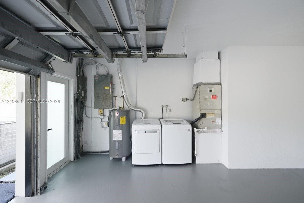 Garage space featuring a painted concrete floor, side-entry door, water heater, and mechanical systems