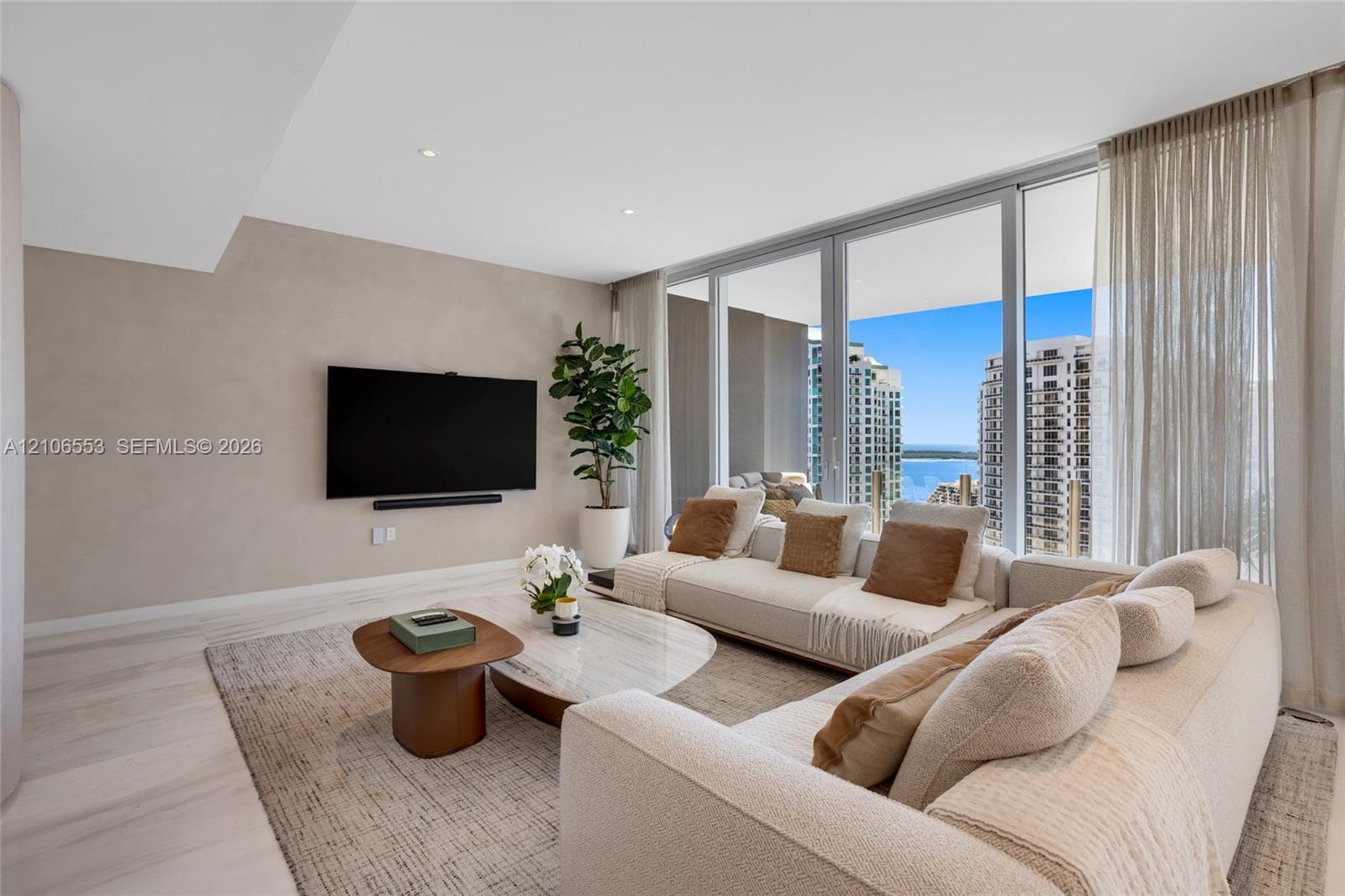 Floor-to-ceiling glass windows, recessed lighting, neutral wall finishes, and wood-finish flooring