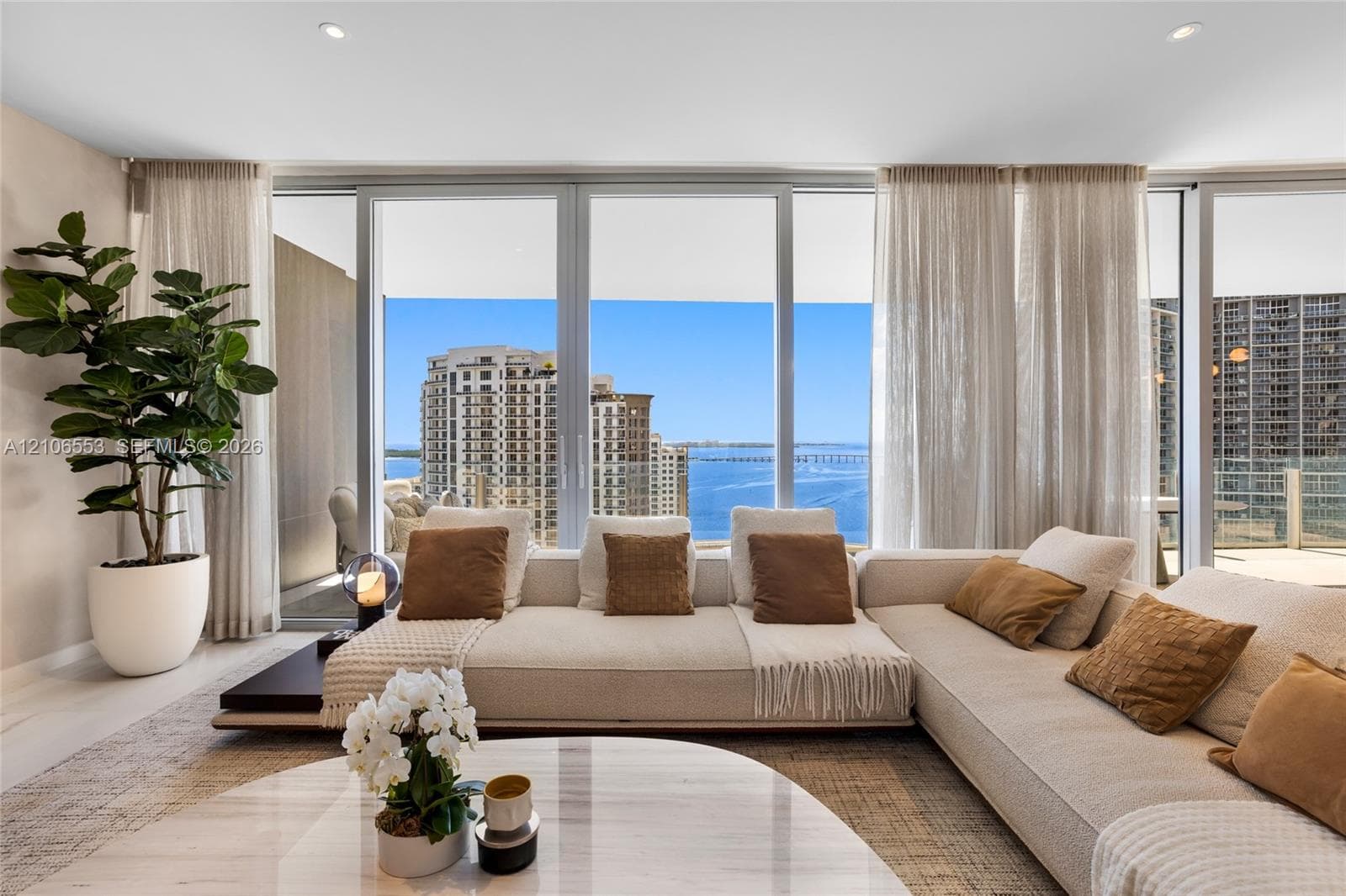 Floor-to-ceiling glass windows, recessed lighting, and neutral wall tones