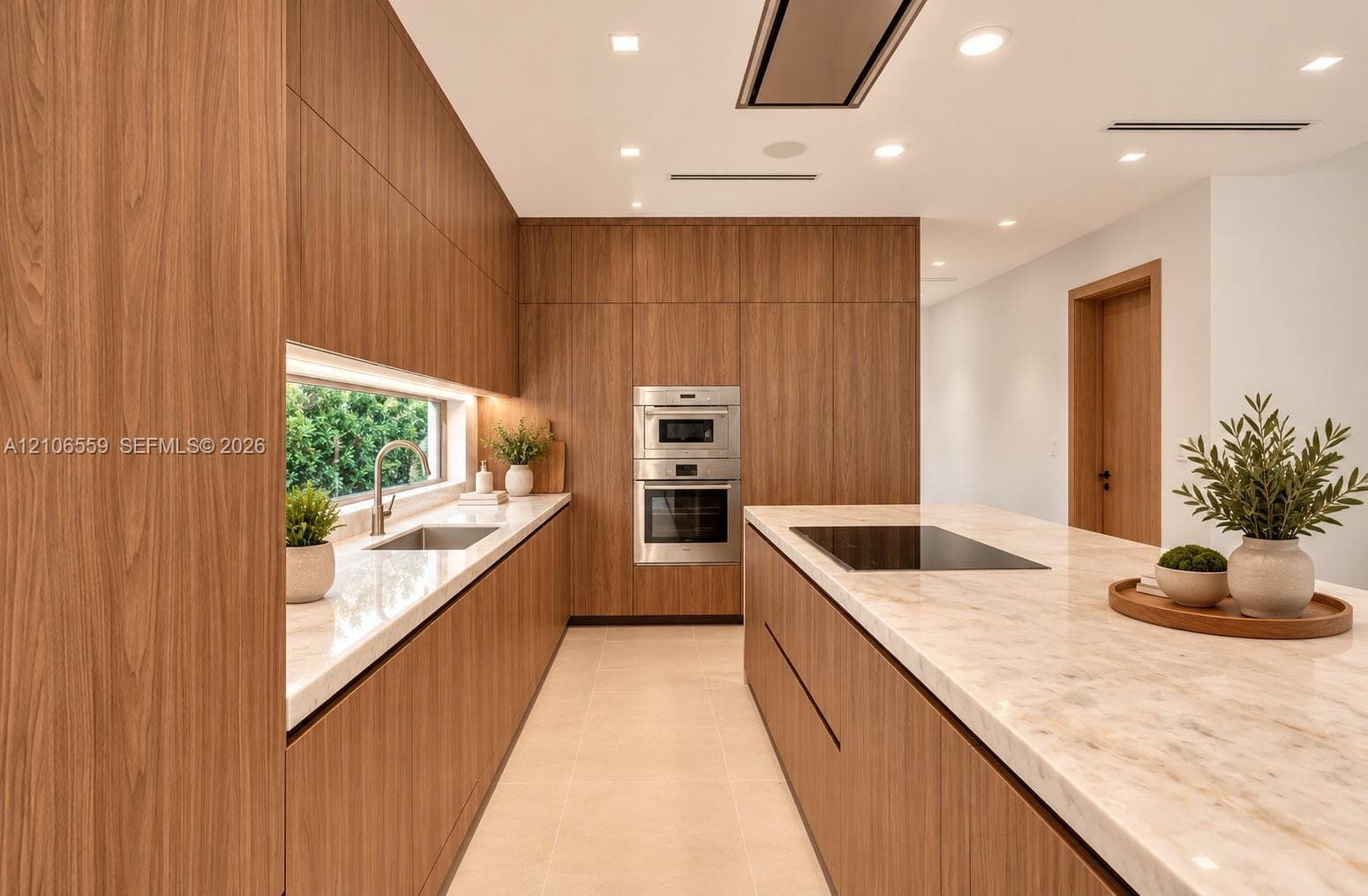 AI staged Modern kitchen featuring full-height wood-finish cabinetry, a central island with a stone-finish countertop, integrated stainless steel double wall ovens, a recessed cooktop, and a horizontal backsplash window
