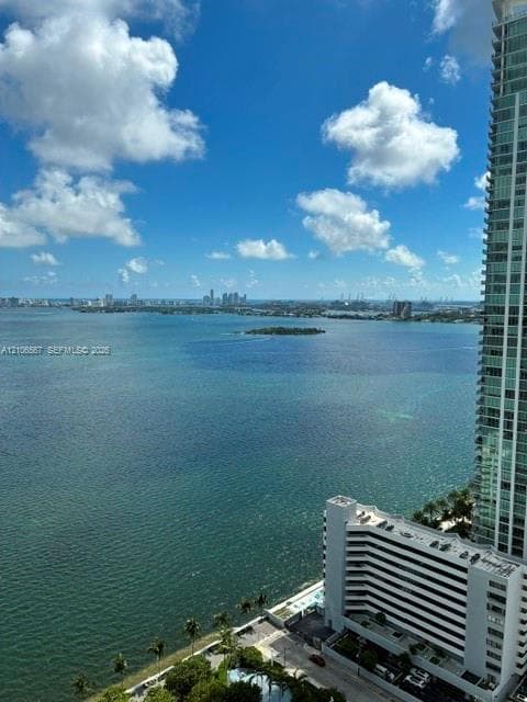 High-rise perspective featuring panoramic coastal water exposure and a distant cityscape horizon