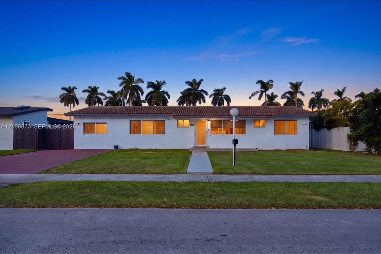 Single-story residence featuring a smooth stucco exterior, a tiled roof, a concrete walkway, and a paved driveway