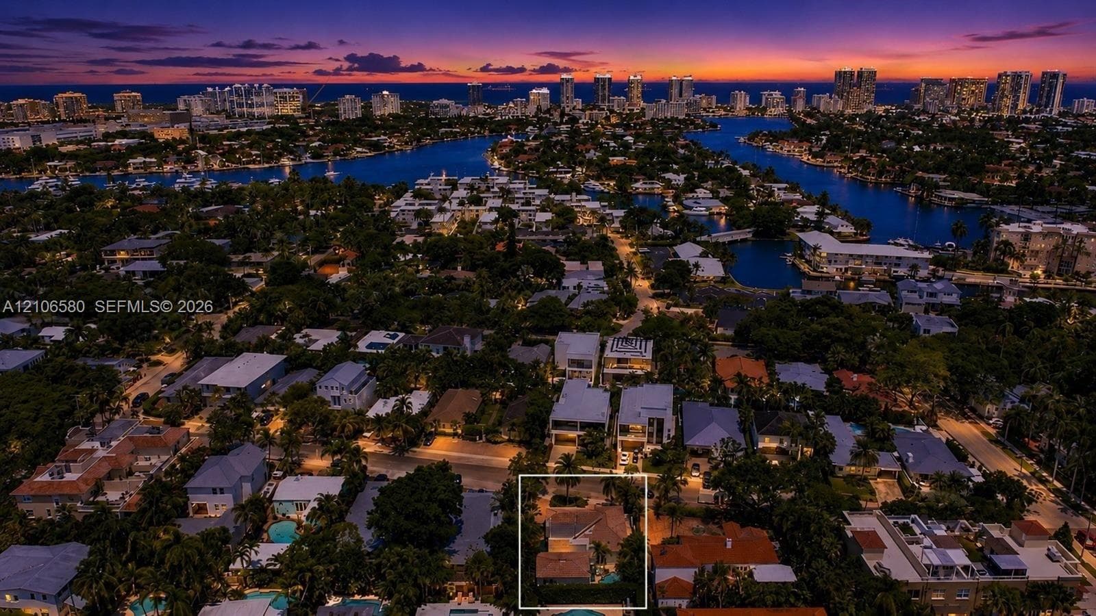 Aerial perspective of residential property featuring a pitched roof, mature landscaping, and a secluded rear yard