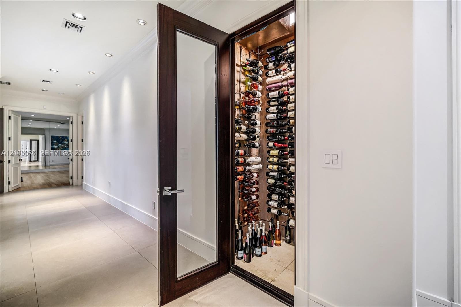 300-bottle, climate-controlled wine storage featuring a wood-finish door with glass inset, structured metal racking, and recessed interior lighting