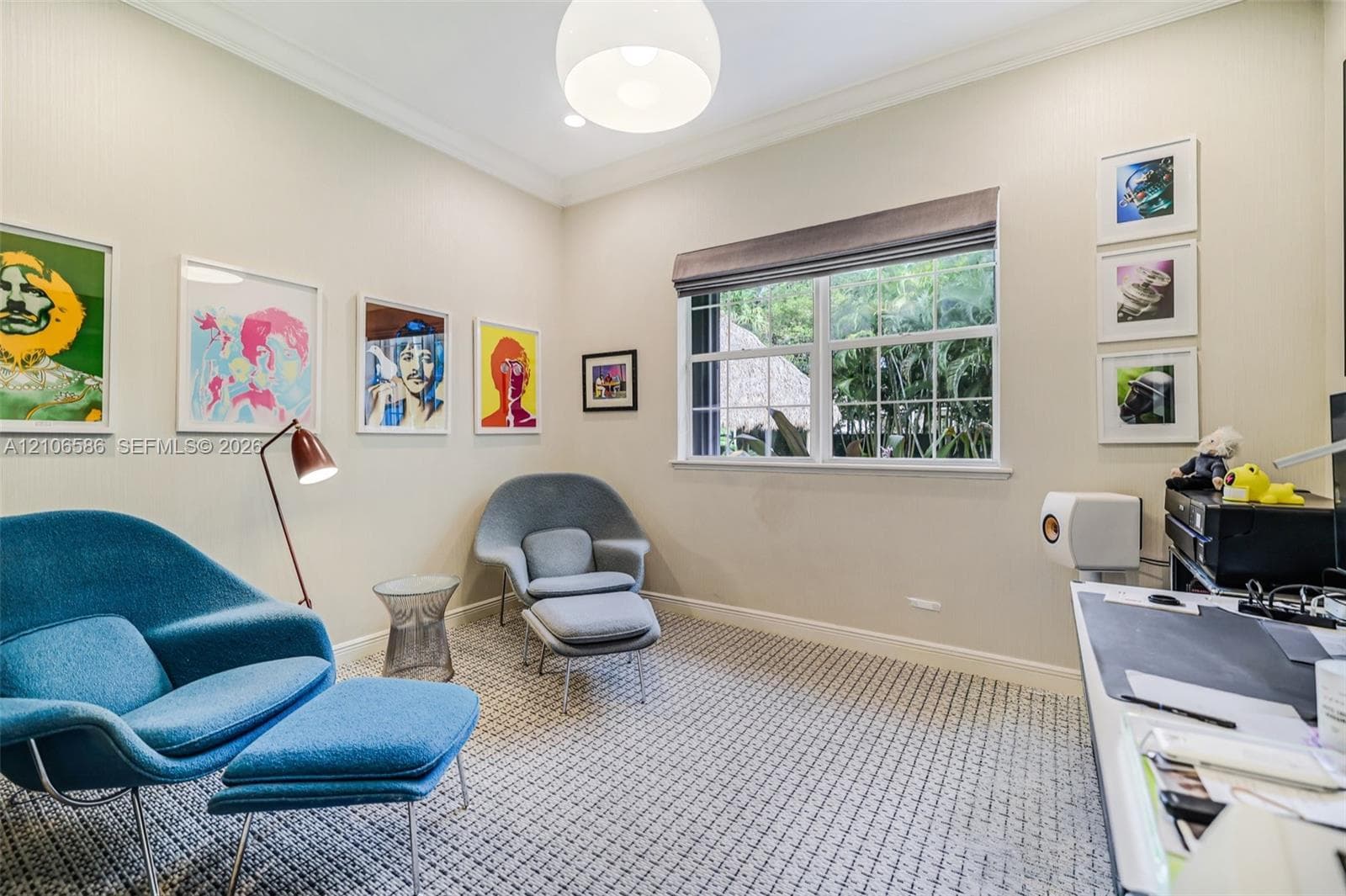 Neutral-toned walls featuring crown molding, patterned carpeting, recessed lighting, a globe pendant fixture, and a large multi-pane window