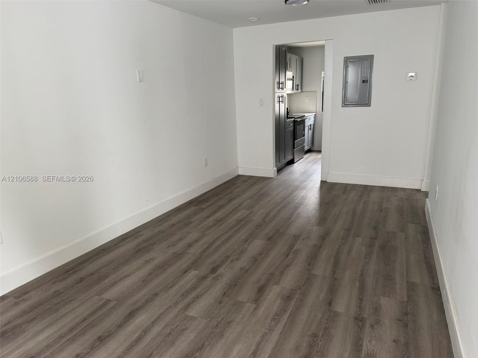 Wood-finish flooring with neutral wall paint and recessed ceiling lighting