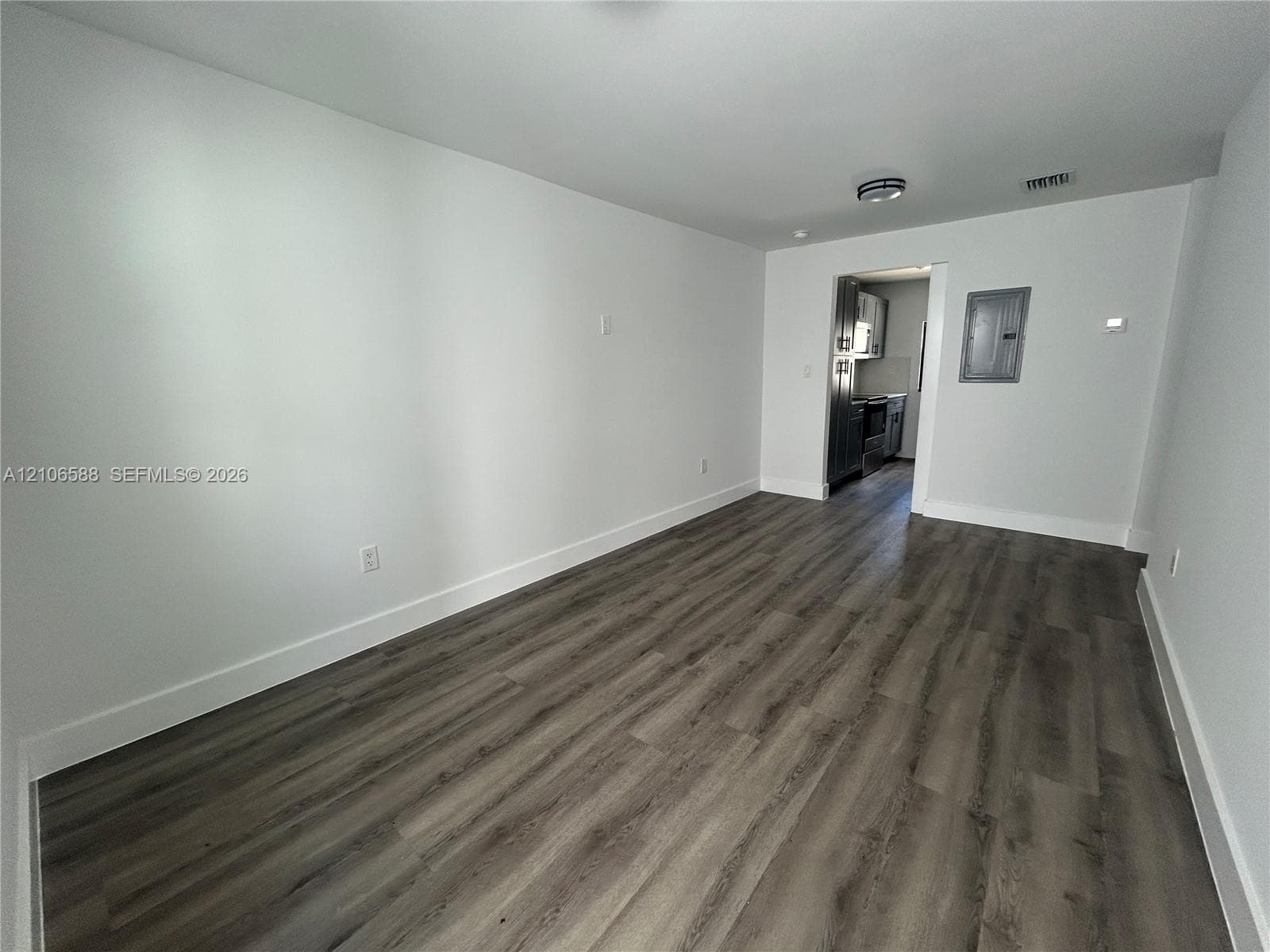 Neutral-toned wood-finish flooring and recessed ceiling lighting