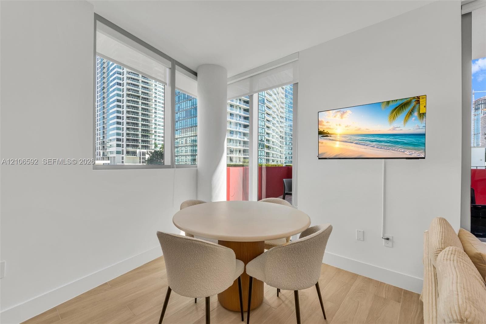 Floor-to-ceiling windows, wood-finish flooring, and structural column