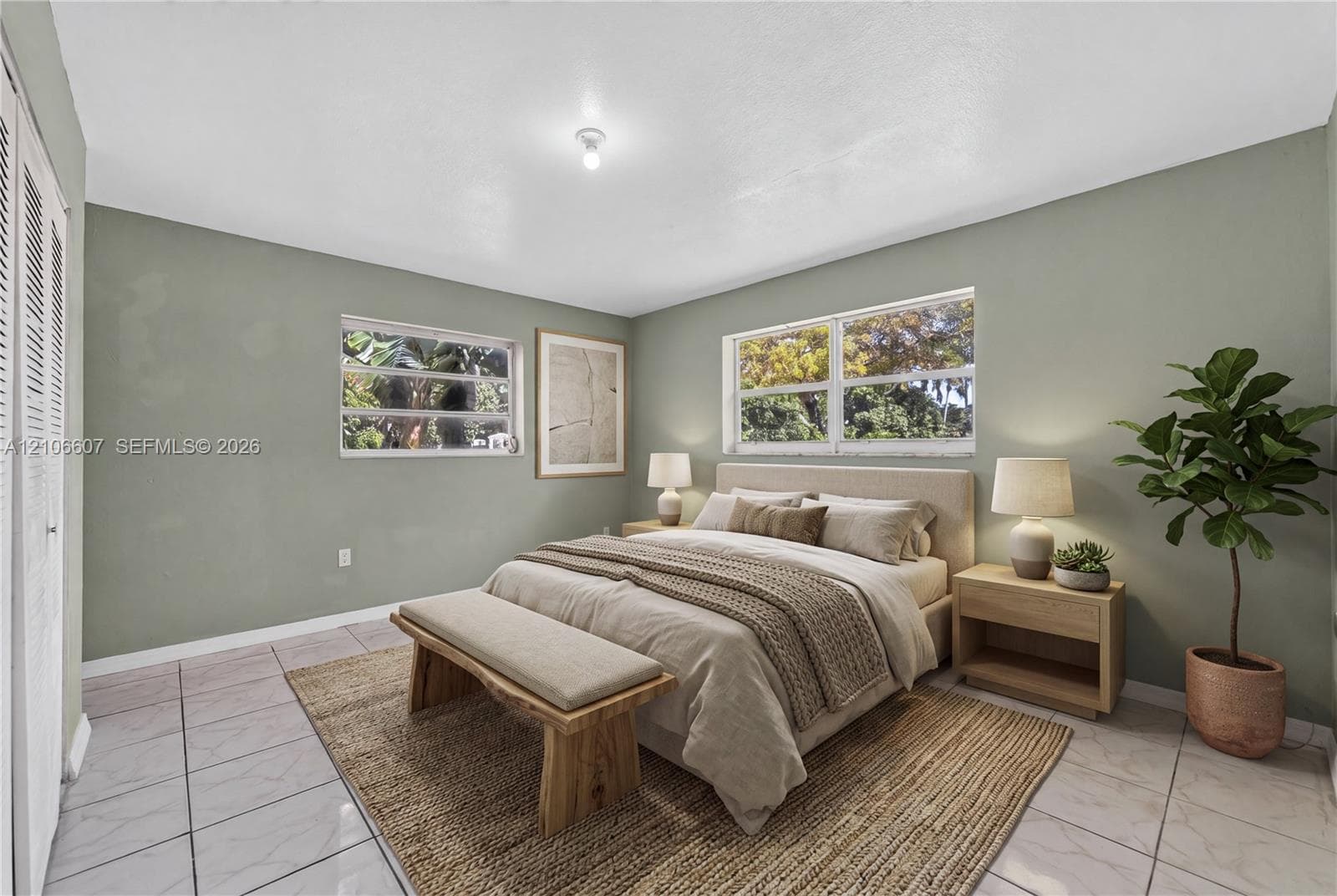 Neutral-toned walls, polished tile flooring, double-hung windows, and white louvered closet doors