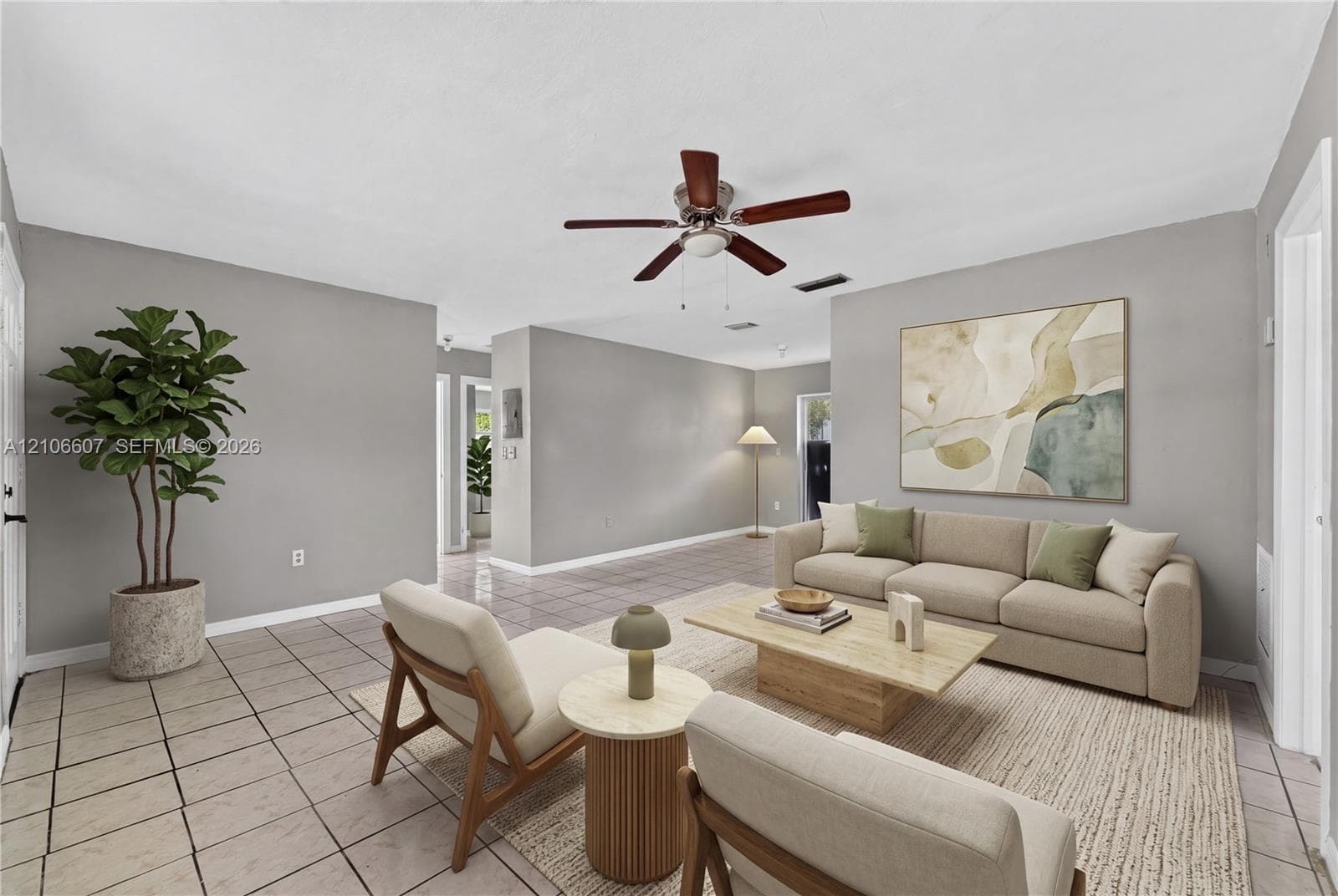 Neutral-toned walls, tile flooring, and a central ceiling fan
