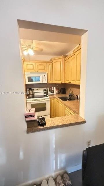 Kitchen featuring wood cabinetry, stone-finish countertops, built-in microwave, integrated range, and an open pass-through window