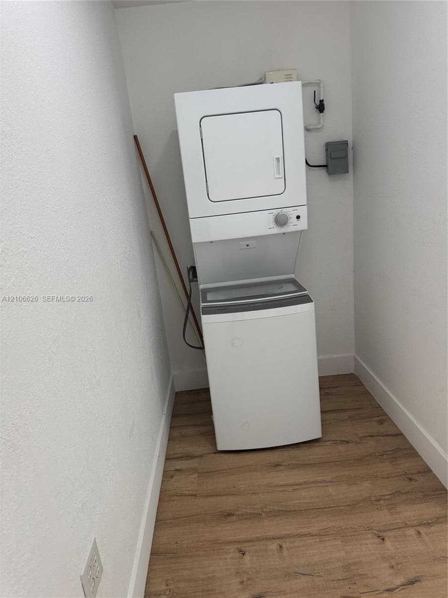 Stacked laundry unit with wood-finish flooring