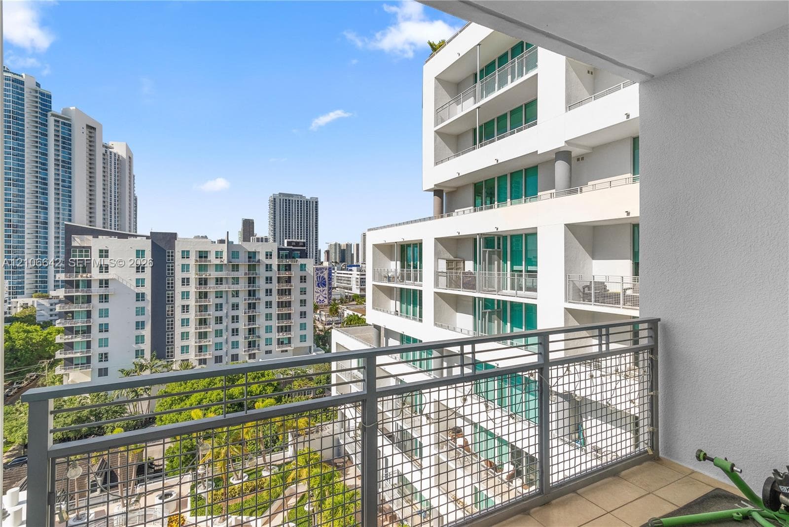 Private balcony featuring tiled flooring and a metal grid railing