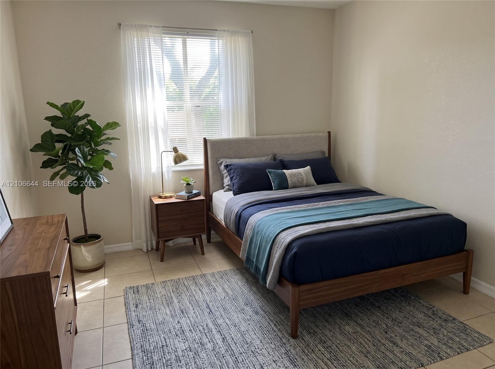 Neutral-toned wall finish, ceramic tile flooring, and a window with horizontal blinds