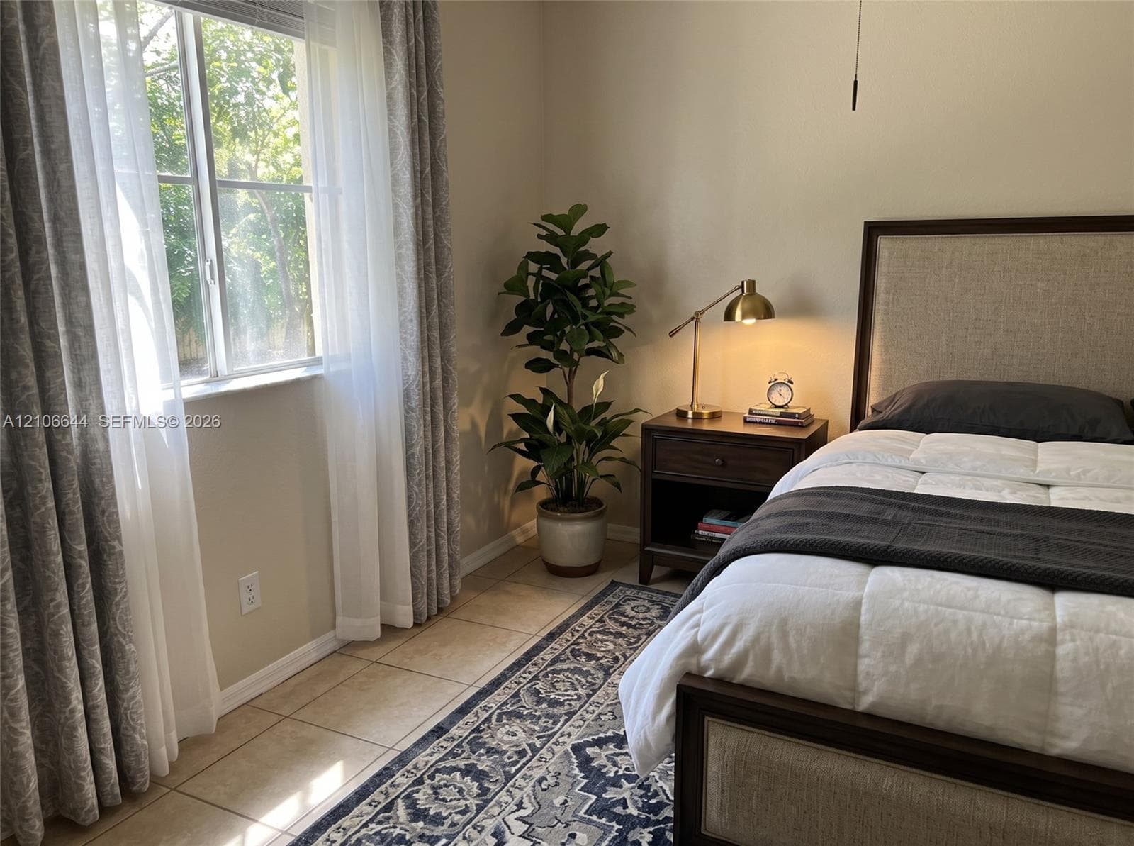 Room with neutral wall tones, large window, and ceramic tile flooring