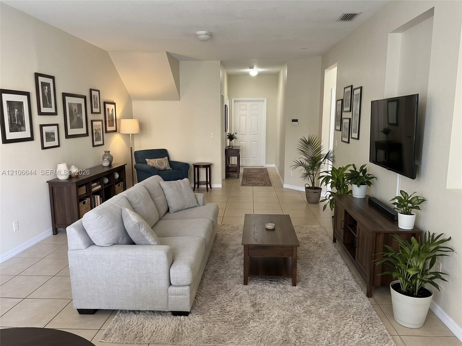 Neutral-toned interior featuring large-format tile flooring and a recessed wall niche