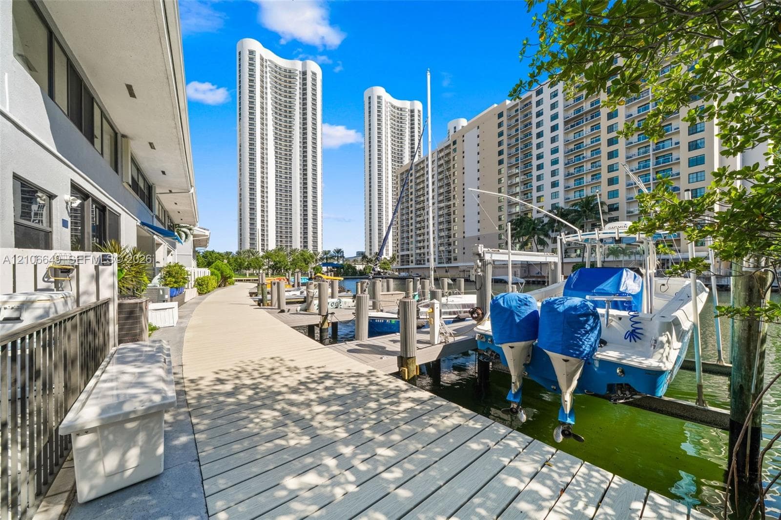 Waterfront property featuring a private composite dock, direct water access, and exterior stairs with integrated landscaping
