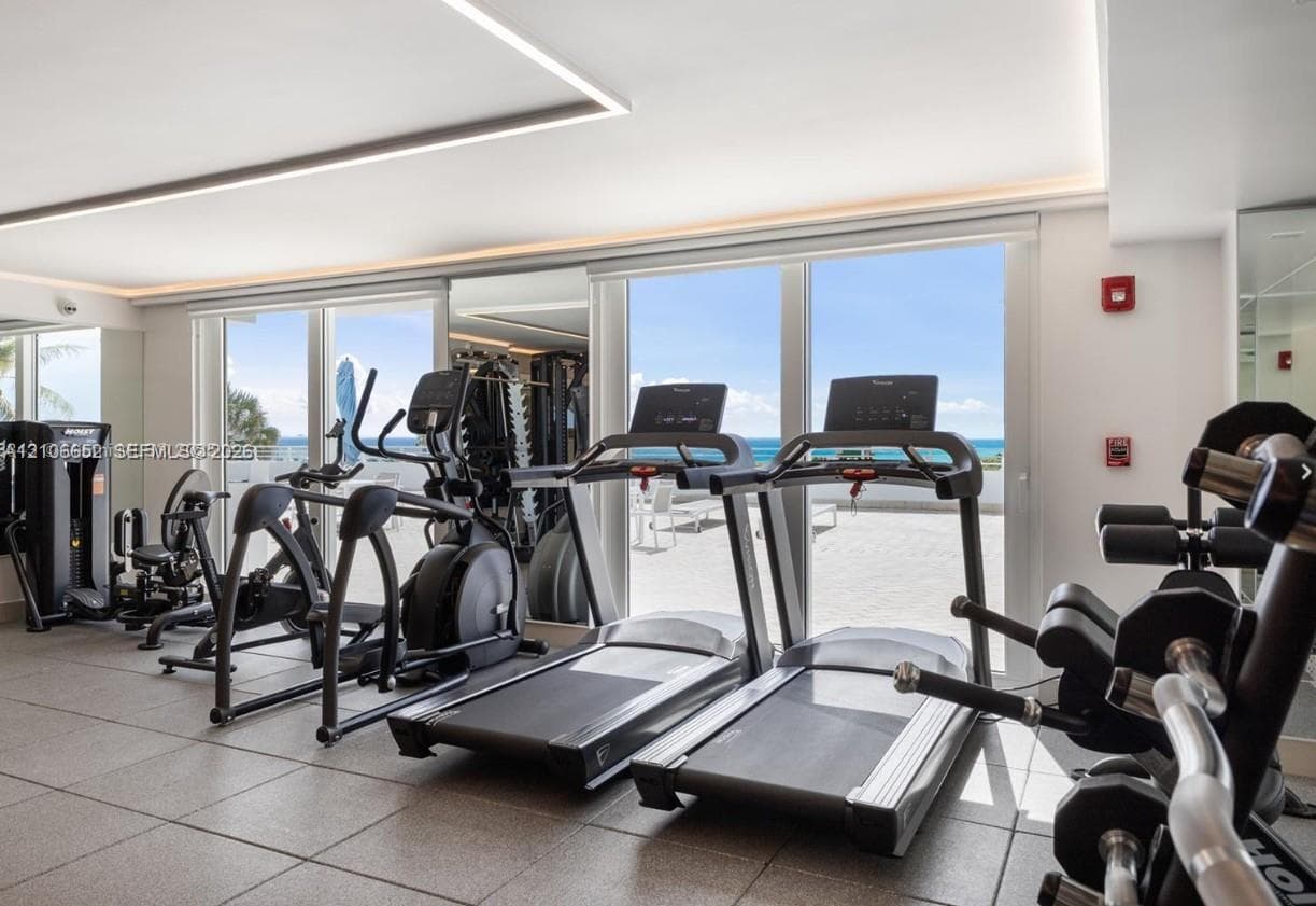 Fitness center featuring serene views of the ocean