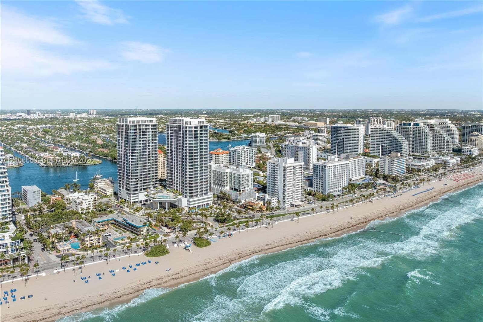 Aerial perspective of coastal high-rise development featuring direct proximity to the Atlantic Ocean shoreline, sandy beaches, and expansive waterfront waterways