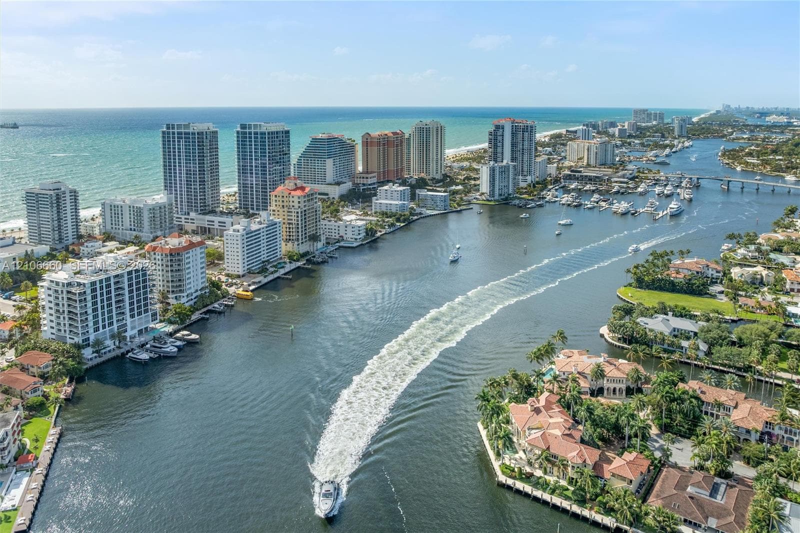 Aerial perspective of the coastline featuring deep-water access, a prominent maritime channel, high-rise buildings, and extensive waterfront properties