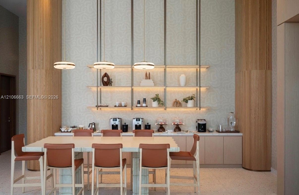 Floor-to-ceiling fluted wood columns, custom wall-mounted open shelving with integrated lighting, minimalist pendant lighting, and sleek custom cabinetry with neutral countertops
