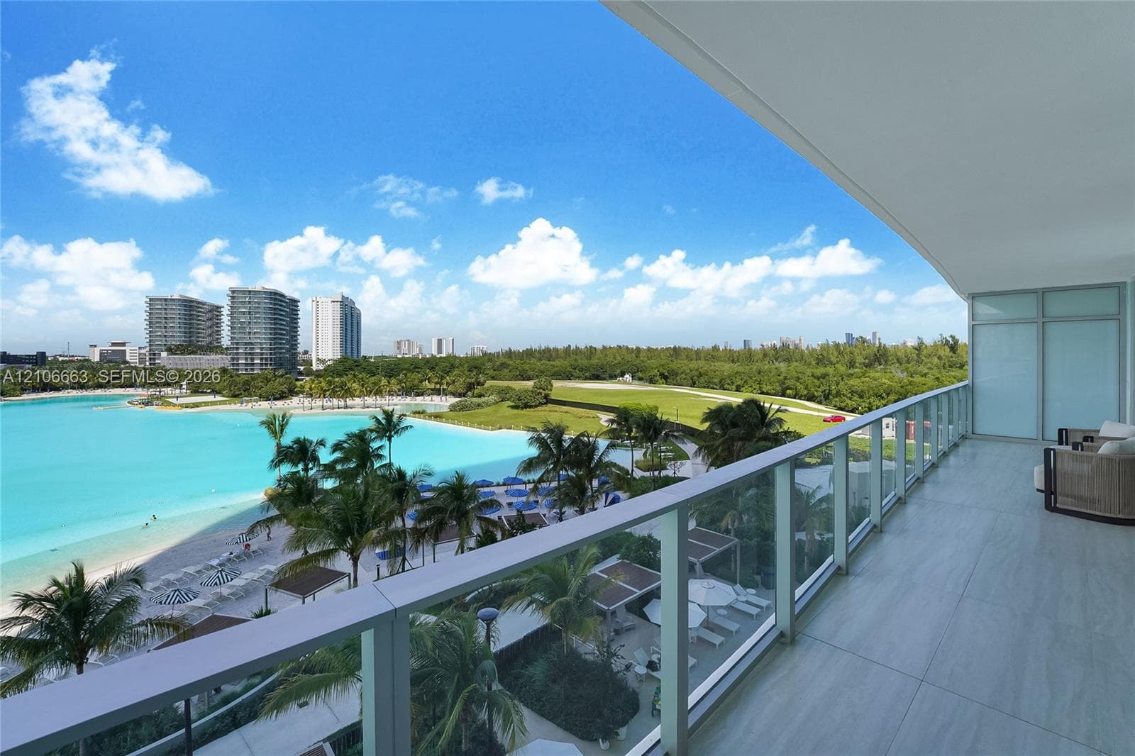 Covered terrace featuring large-format tile flooring and a glass-paneled railing