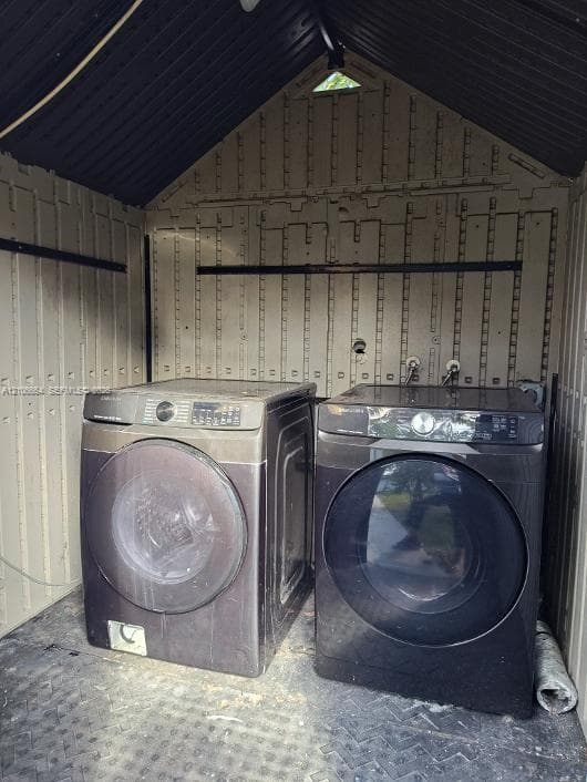Utility structure featuring resin walls, vaulted ceiling, diamond-plate flooring, and dual laundry hookups