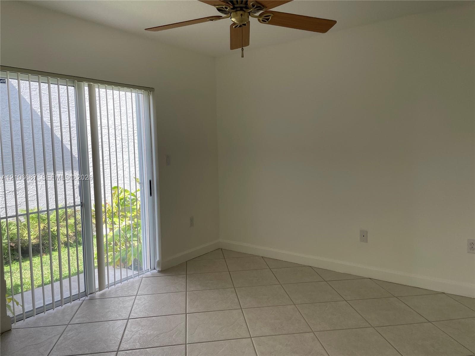 Ceramic tile flooring, neutral wall finishes, ceiling fan, and sliding glass patio door