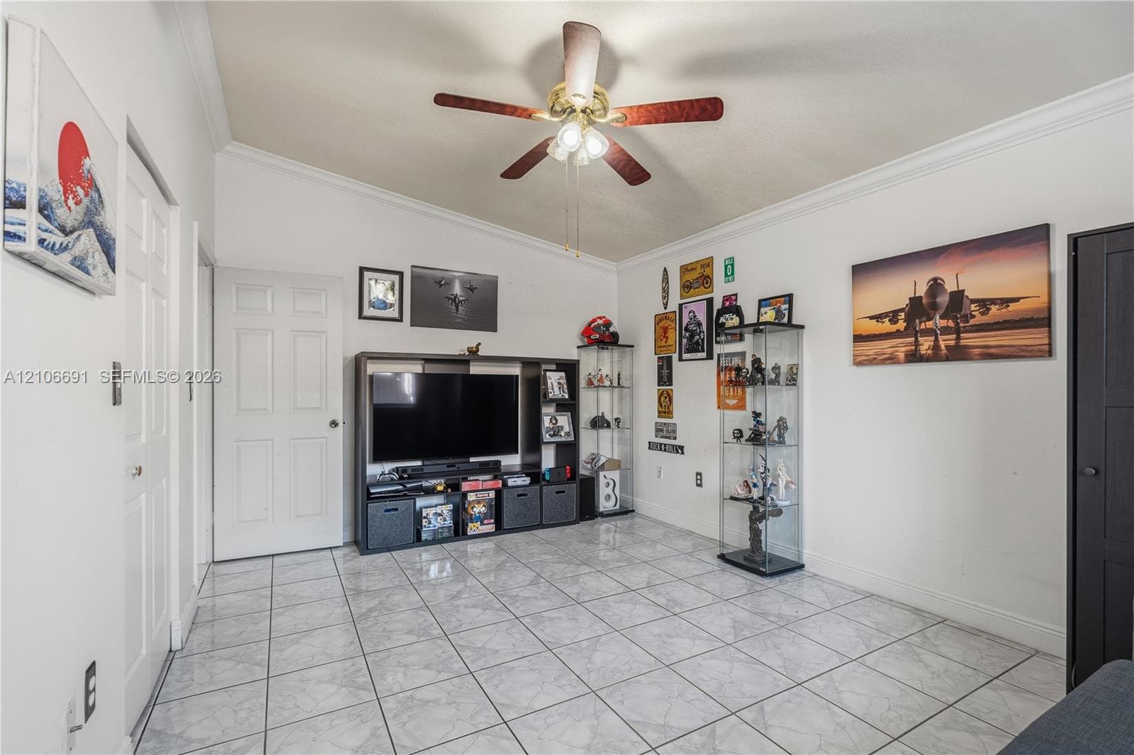 Vaulted ceiling featuring a central multi-blade light fixture and ceramic tile flooring