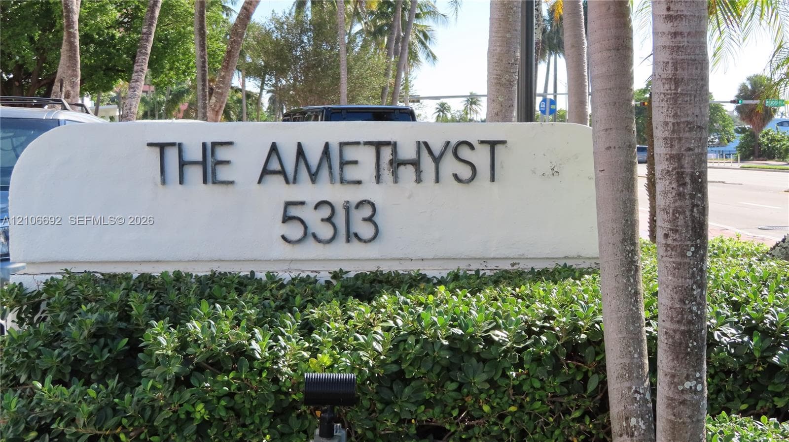 Stucco monument signage featuring dimensional lettering and integrated landscape shrubbery
